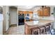 Functional kitchen with wood cabinets, granite countertops, stainless steel appliances, and a cozy breakfast bar at 17766 W Caribbean Ln, Surprise, AZ 85388