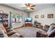 Bright living room with a large TV, comfortable seating, and a view of the backyard at 17766 W Caribbean Ln, Surprise, AZ 85388