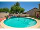 Inviting backyard pool with a cleaning system, surrounded by desert landscaping and brick trim at 17766 W Caribbean Ln, Surprise, AZ 85388