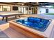 This backyard paradise features a hot tub, outdoor TV, and pool table for unforgettable entertainment and relaxation at 1861 W Navarro Ave, Mesa, AZ 85202
