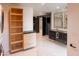 Bright modern bathroom featuring marble floors, floating dual vanity with black cabinets, and stylish decorative mirrors at 1861 W Navarro Ave, Mesa, AZ 85202
