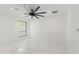 Bright, minimalist bedroom with marble floors, recessed lighting, and a modern ceiling fan at 1861 W Navarro Ave, Mesa, AZ 85202