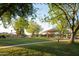 Enjoy the lush green grass, mature shade trees and covered playground in this Gathering-friendly community park at 1861 W Navarro Ave, Mesa, AZ 85202