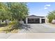 Charming single-story home with a modern garage door and well-maintained landscaping at 1861 W Navarro Ave, Mesa, AZ 85202
