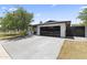 Beautiful single-story home with modern garage door and lush landscaping, creating a welcoming curb appeal at 1861 W Navarro Ave, Mesa, AZ 85202