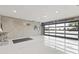 Bright, spacious garage with epoxy flooring and a modern glass panel door, perfect for car enthusiasts at 1861 W Navarro Ave, Mesa, AZ 85202