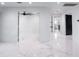 Bright hallway with marble floors and recessed lighting, leading to various rooms in the house at 1861 W Navarro Ave, Mesa, AZ 85202