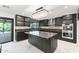 Modern kitchen with custom cabinetry, marble countertops, and a view of the backyard at 1861 W Navarro Ave, Mesa, AZ 85202