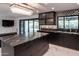 Elegant kitchen with marble countertops, custom cabinets, modern lighting, and backyard access at 1861 W Navarro Ave, Mesa, AZ 85202