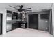 Modern kitchen features black countertops and a large ceiling fan with integrated lighting at 1861 W Navarro Ave, Mesa, AZ 85202