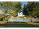 Scenic view of a tranquil lake surrounded by lush greenery and beautiful homes under a clear blue sky at 1861 W Navarro Ave, Mesa, AZ 85202