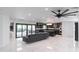 Open living room with view of the kitchen, and featuring marble floors and a ceiling fan at 1861 W Navarro Ave, Mesa, AZ 85202