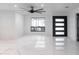 Bright living room with marble floors, a modern ceiling fan, and a view of the outdoor patio at 1861 W Navarro Ave, Mesa, AZ 85202