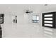 Bright living room with marble flooring, modern fixtures, and black paneled door at 1861 W Navarro Ave, Mesa, AZ 85202