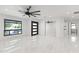 Spacious living room with large window, sleek ceiling fan, and elegant marble flooring at 1861 W Navarro Ave, Mesa, AZ 85202