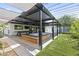 Outdoor patio area with a spa, tv, and modern shade structure and landscaping that is perfect for entertaining guests at 1861 W Navarro Ave, Mesa, AZ 85202