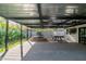 Covered patio with a spa, pool table, and ample space for entertaining, creating an ideal outdoor living area at 1861 W Navarro Ave, Mesa, AZ 85202
