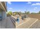 The backyard boasts a paver patio, fire pit, hot tub, grill, and tasteful desert landscaping at 18865 W Mescal St, Surprise, AZ 85388