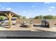 Spacious backyard with a built-in firepit, grill, lounge furniture, and covered hot tub at 18865 W Mescal St, Surprise, AZ 85388