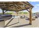 Paver patio featuring a hot tub, pergola, outdoor grill, and a charming gas fire pit at 18865 W Mescal St, Surprise, AZ 85388
