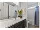 Bathroom with a dual-door entry, a dark vanity, and a bathtub-shower, with modern finishes at 18865 W Mescal St, Surprise, AZ 85388