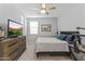Cozy bedroom with soft carpet, ceiling fan, large dresser, and TV; perfect for relaxation at 18865 W Mescal St, Surprise, AZ 85388