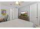 This bedroom features a ceiling fan, a dresser with TV, carpet, and a doorway to another room at 18865 W Mescal St, Surprise, AZ 85388