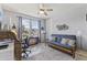 Well-lit bonus room with a futon, desk, printer, decor, and a large double-paned window at 18865 W Mescal St, Surprise, AZ 85388