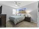 Serene bedroom featuring a ceiling fan and a desert landscape photo at 18865 W Mescal St, Surprise, AZ 85388