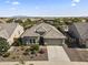 A charming single-story home boasts desert landscaping and a two-car garage in a peaceful suburban neighborhood at 18865 W Mescal St, Surprise, AZ 85388