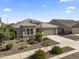 A charming single-story home boasts desert landscaping and a two-car garage in a peaceful suburban neighborhood at 18865 W Mescal St, Surprise, AZ 85388