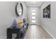 Elegant foyer with modern lighting fixtures, decorative accents, and wood-look tile flooring at 18865 W Mescal St, Surprise, AZ 85388