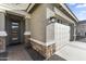 Close-up view of front entrance and two-car garage with decorative stone accents at 18865 W Mescal St, Surprise, AZ 85388