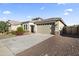 Inviting single-story house with low maintenance landscaping and a convenient two-car garage at 18865 W Mescal St, Surprise, AZ 85388