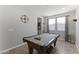 Spacious game room featuring a pool table, neutral walls and tile flooring at 18865 W Mescal St, Surprise, AZ 85388