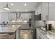 Contemporary kitchen with gray cabinetry, subway tile backsplash, and stainless steel appliances at 18865 W Mescal St, Surprise, AZ 85388