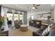Inviting living room with a view of the backyard, flowing into the kitchen and dining areas at 18865 W Mescal St, Surprise, AZ 85388