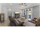 Inviting living room featuring tile floors, ceiling fan, and access to the outdoor space at 18865 W Mescal St, Surprise, AZ 85388