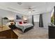 Spacious main bedroom with tray ceiling, ceiling fan, carpet and comfortable king bed at 18865 W Mescal St, Surprise, AZ 85388
