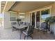 Covered patio features a large outdoor table and chairs, and a sliding glass door into the home at 18865 W Mescal St, Surprise, AZ 85388