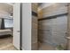 Modern tile shower with wood-look accents, grab bar and easy access to the main bedroom at 18865 W Mescal St, Surprise, AZ 85388