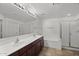 Bright bathroom featuring double sink vanity, soaking tub, and glass enclosed shower at 19700 N 76Th St # 1103, Scottsdale, AZ 85255
