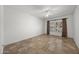 Spacious bedroom featuring a ceiling fan and tile flooring with window and custom curtains at 19700 N 76Th St # 1103, Scottsdale, AZ 85255