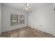 Empty bedroom with tile floor, ceiling fan, and two windows with blinds at 19700 N 76Th St # 1103, Scottsdale, AZ 85255