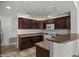 Well-lit kitchen with dark wood cabinetry and modern appliances at 19700 N 76Th St # 1103, Scottsdale, AZ 85255
