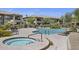 Community pool and hot tub surrounded by lounge chairs and desert landscaping at 19700 N 76Th St # 1103, Scottsdale, AZ 85255