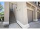 Exterior view of the condo featuring a private entrance, staircase, and direct garage access at 19700 N 76Th St # 2057, Scottsdale, AZ 85255
