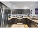Modern kitchen with stainless steel appliances and stylish dark cabinetry for a sleek, updated look at 19700 N 76Th St # 2057, Scottsdale, AZ 85255