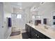 Well lit main bathroom with double sinks, large shower and framed glass shower door at 19700 N 76Th St # 2057, Scottsdale, AZ 85255