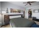 This main bedroom features a large bed, walk in closet, and an eye-catching city skyline art piece at 19700 N 76Th St # 2057, Scottsdale, AZ 85255